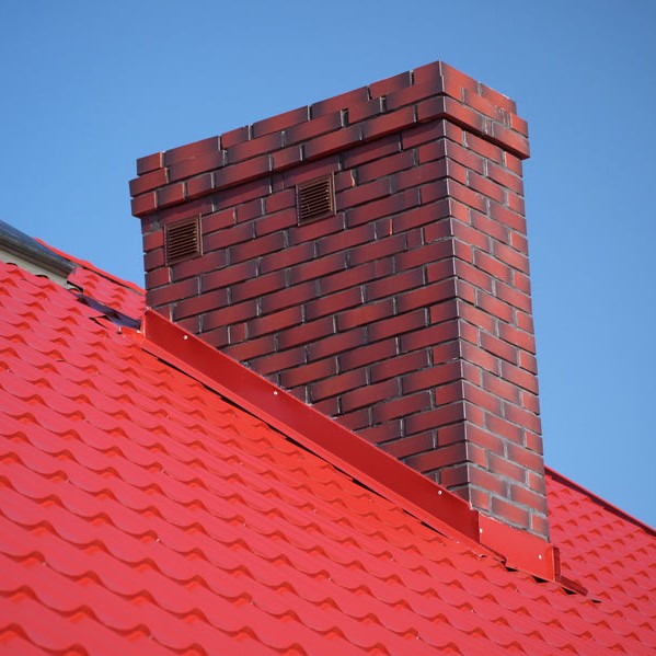 Chimney on roof with metal flashing